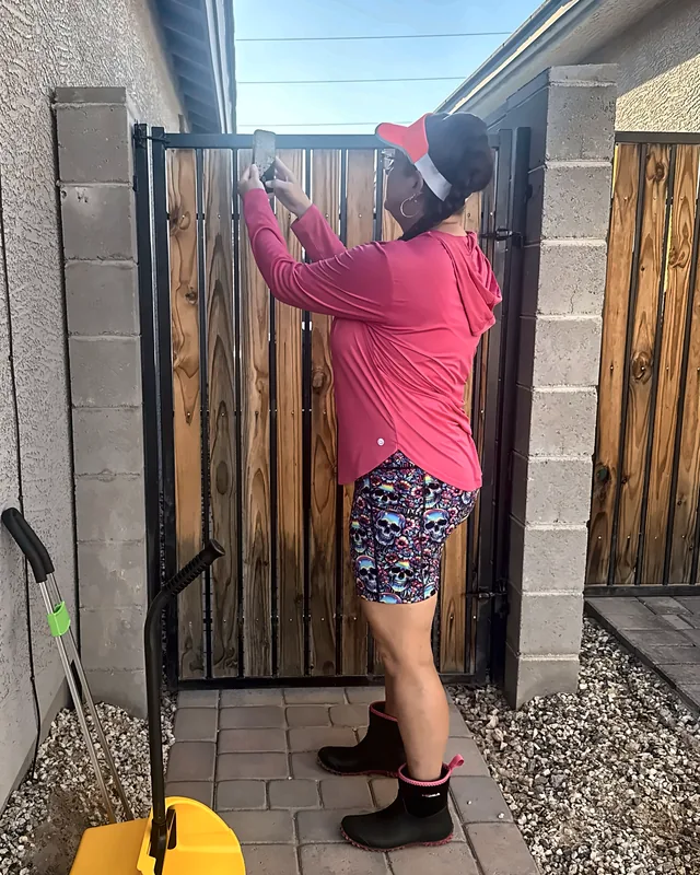 Britni taking a photo of the backyard gate